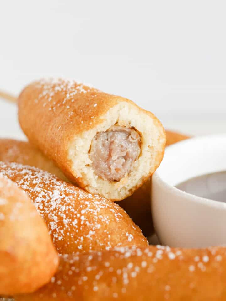 Inside view of breakfast corn dog with sausage link in the middle