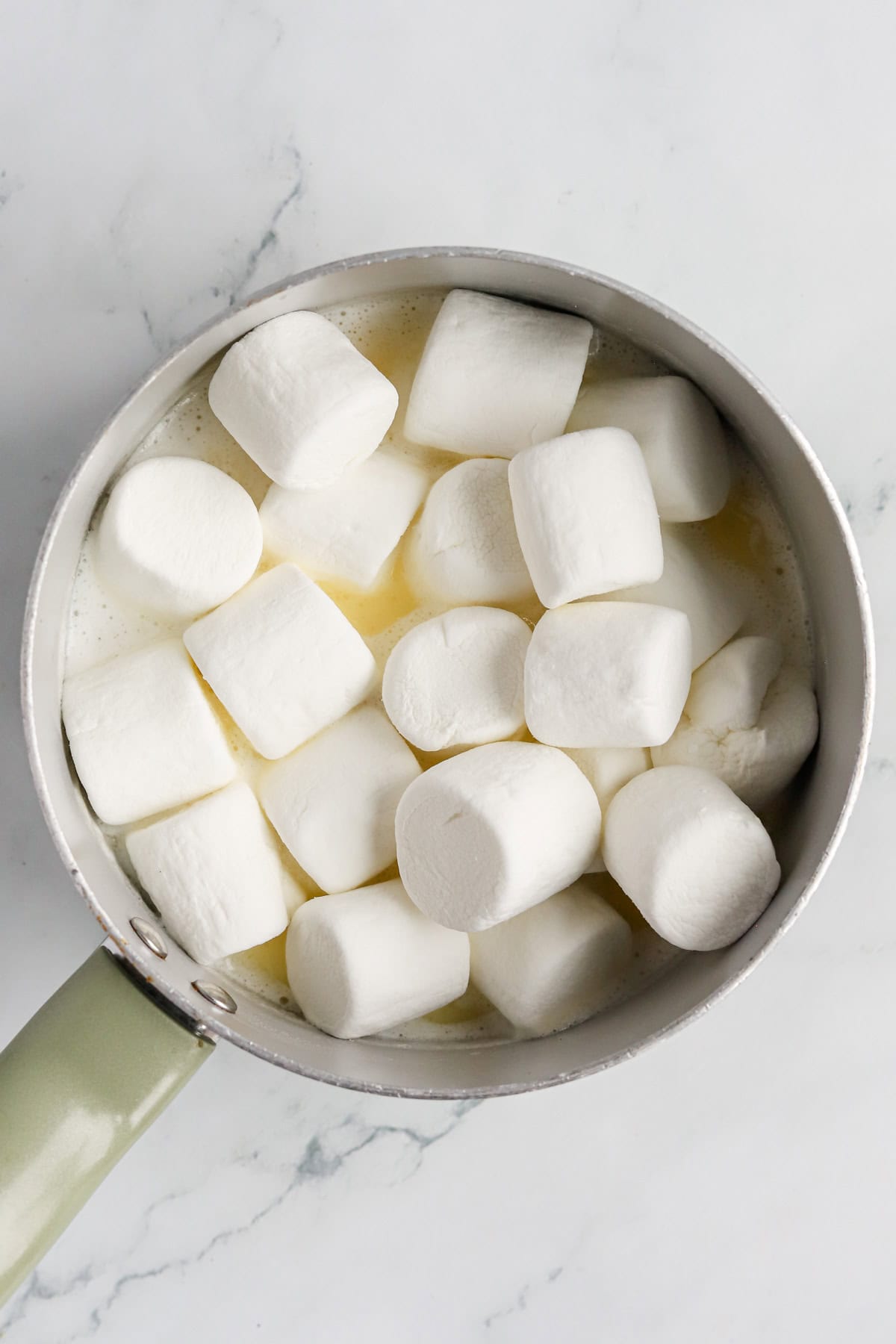 Marshmallows added to sauce pan of melted butter and milk.