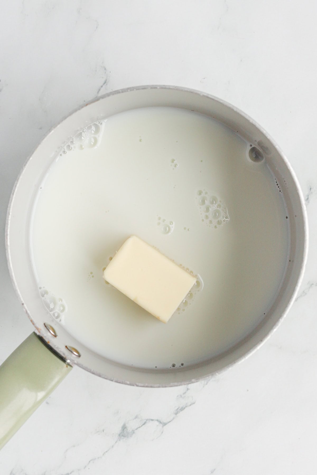 Butter and milk in a saucepan.