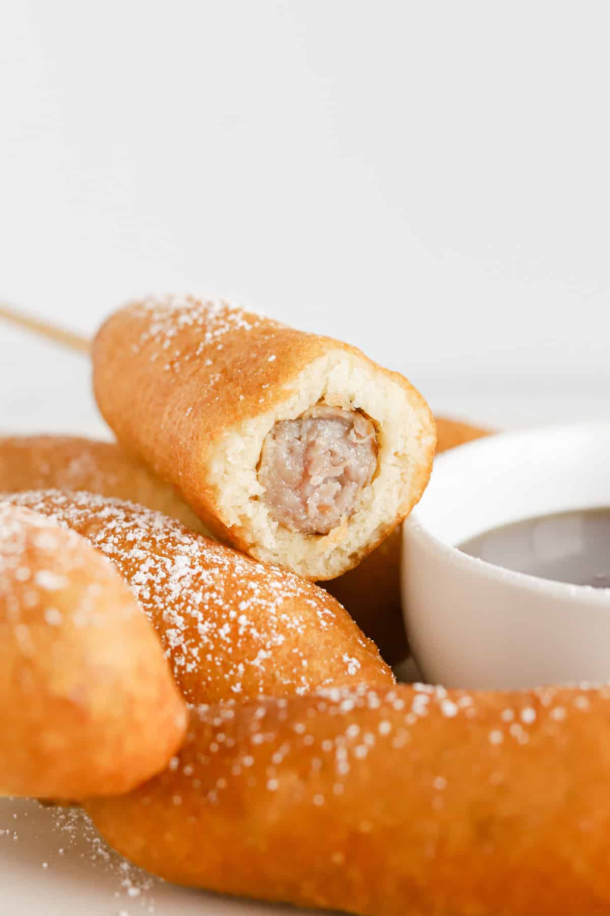 Inside view of breakfast corn dog with sausage link in the middle