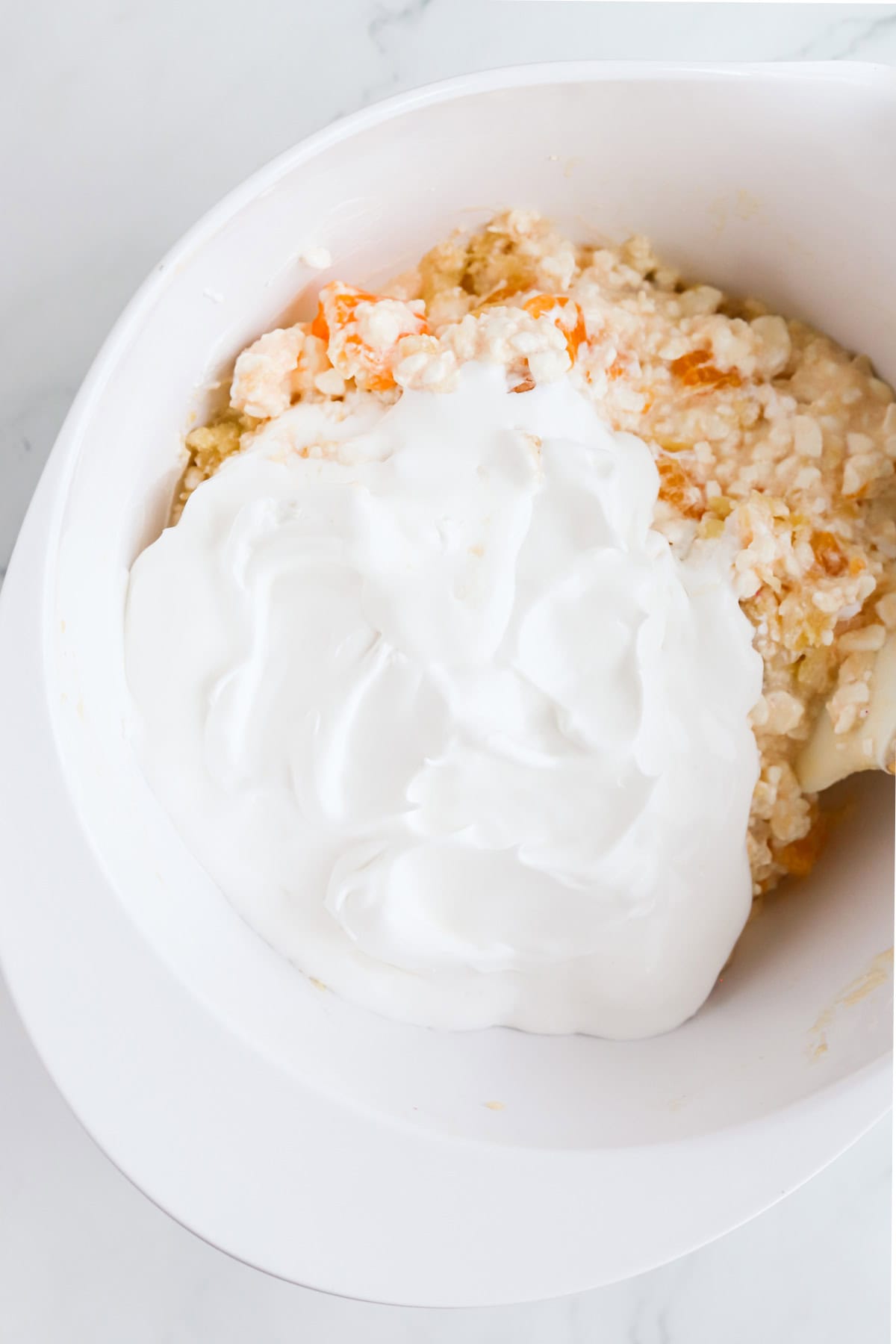 Whipped topping added to orange cottage cheese salad.