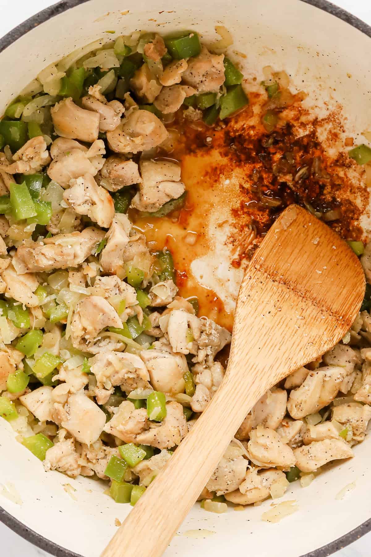 Chicken thigh chunks, green pepper and onion sautéed in bottom of dutch oven.