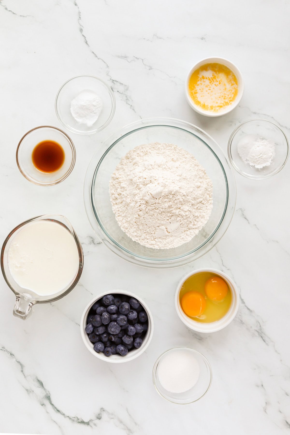 Pancake ingredients laid out on marble countertop.