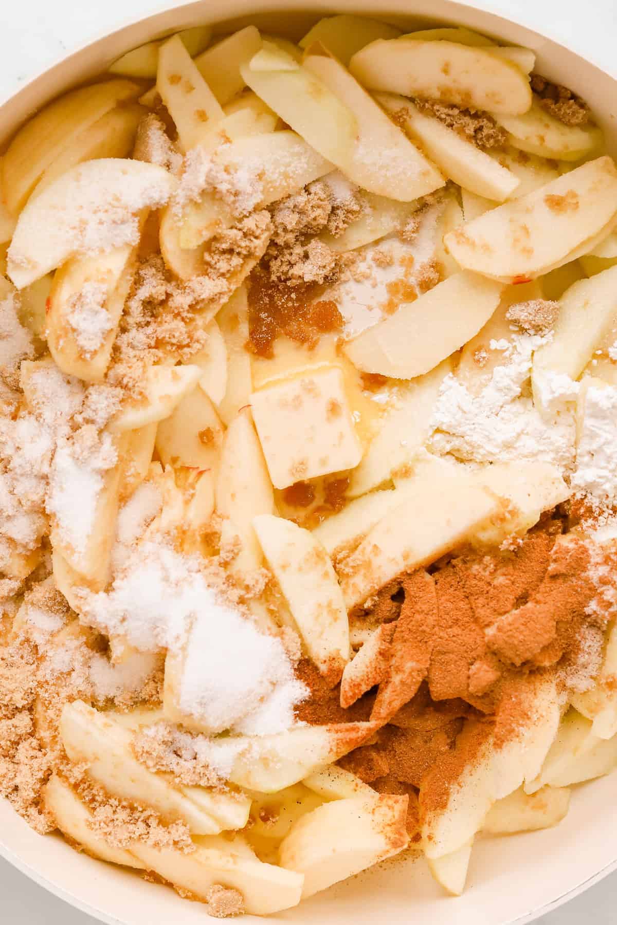 Sliced apples, flour, butter, spices and brown sugar in a skillet