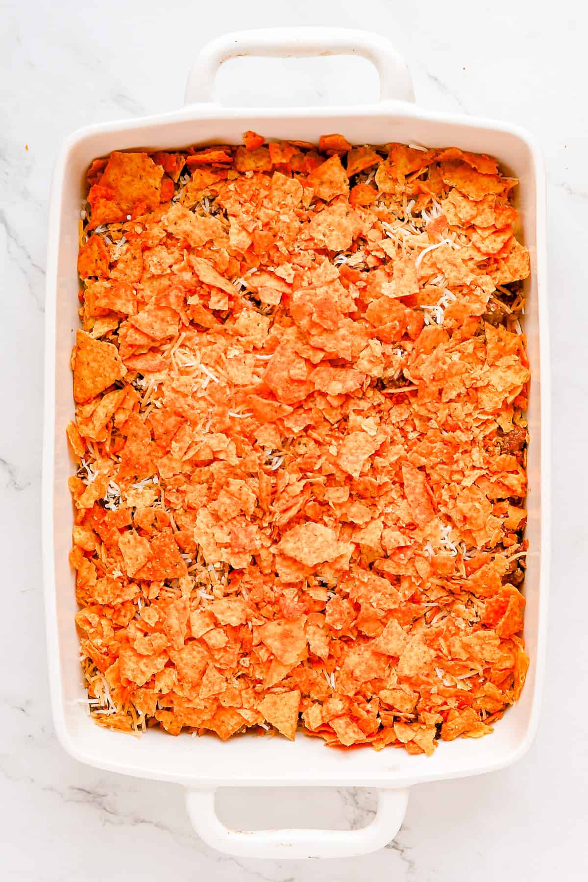 Second layer of crushed Doritos on top of meat mixture.