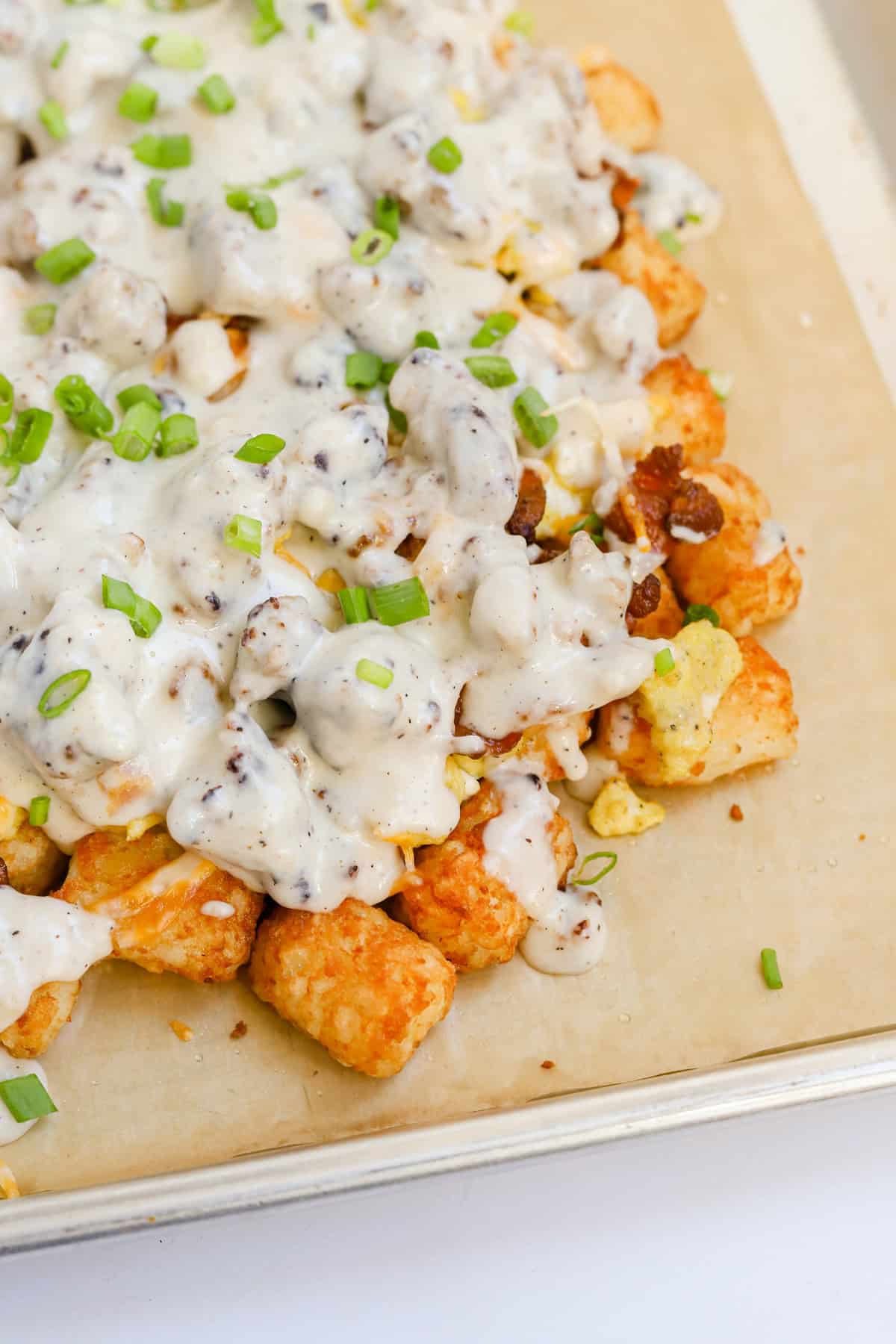 Breakfast totchos on parchment lined sheet pan.