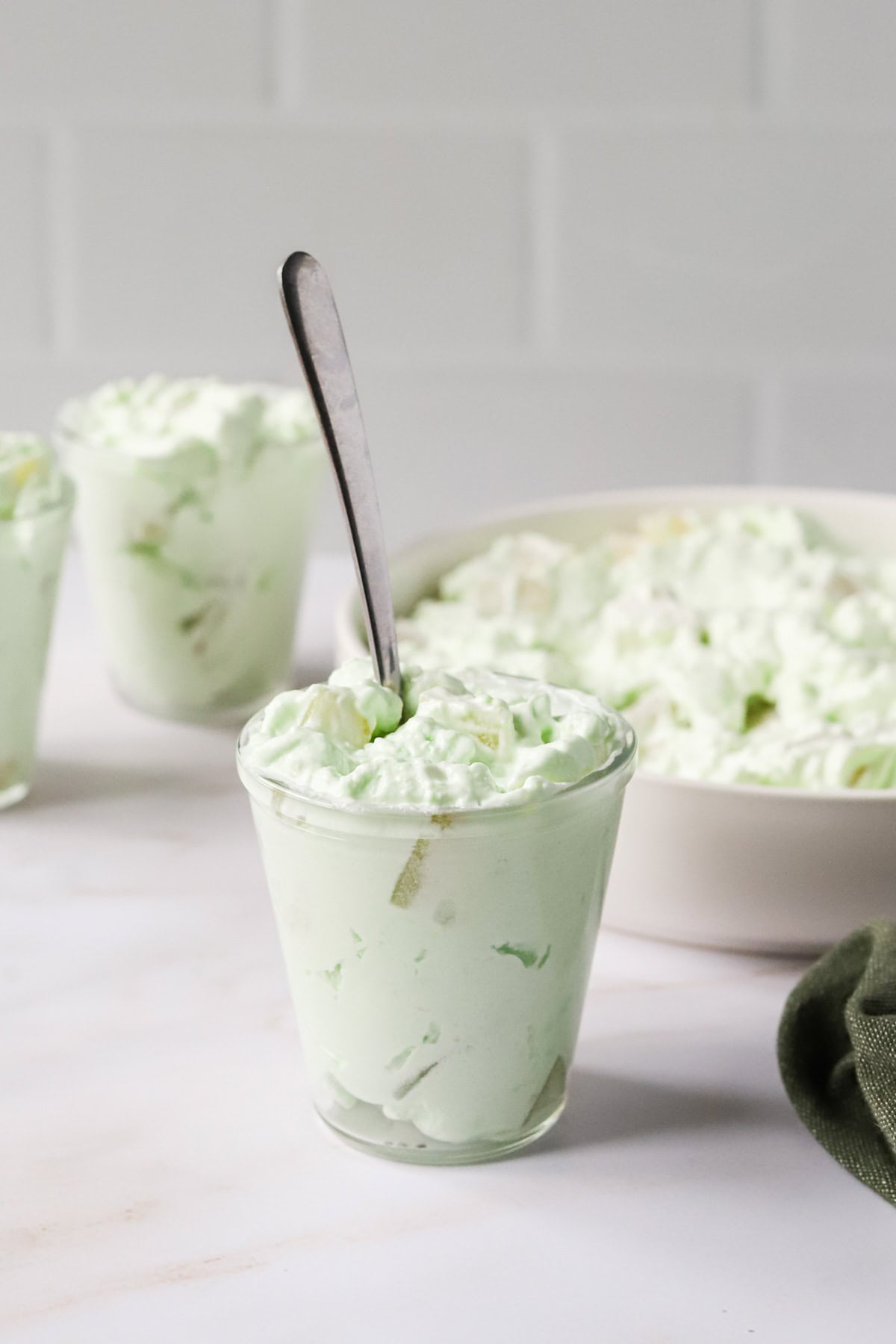 Seafoam salad in glass jars on countertop.