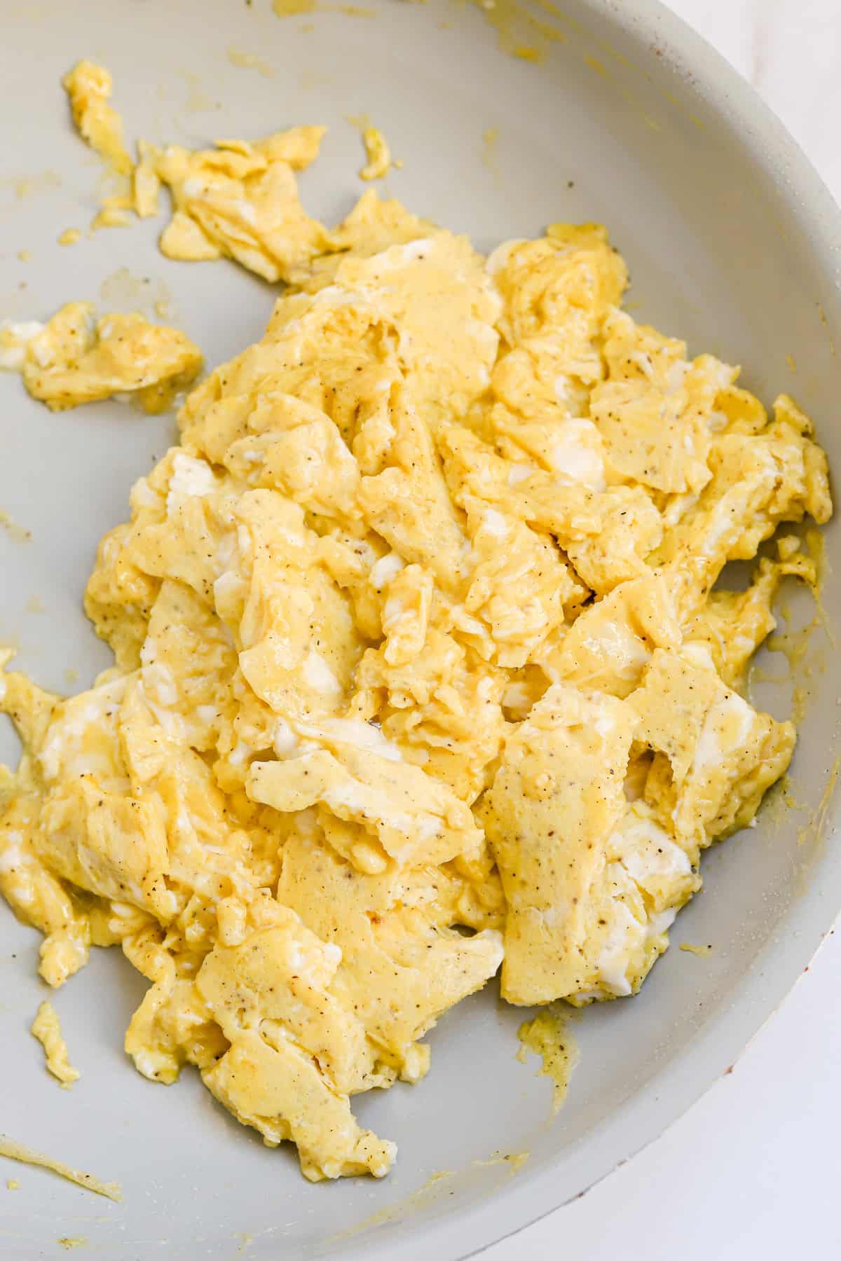 Scrambled eggs in skillet.