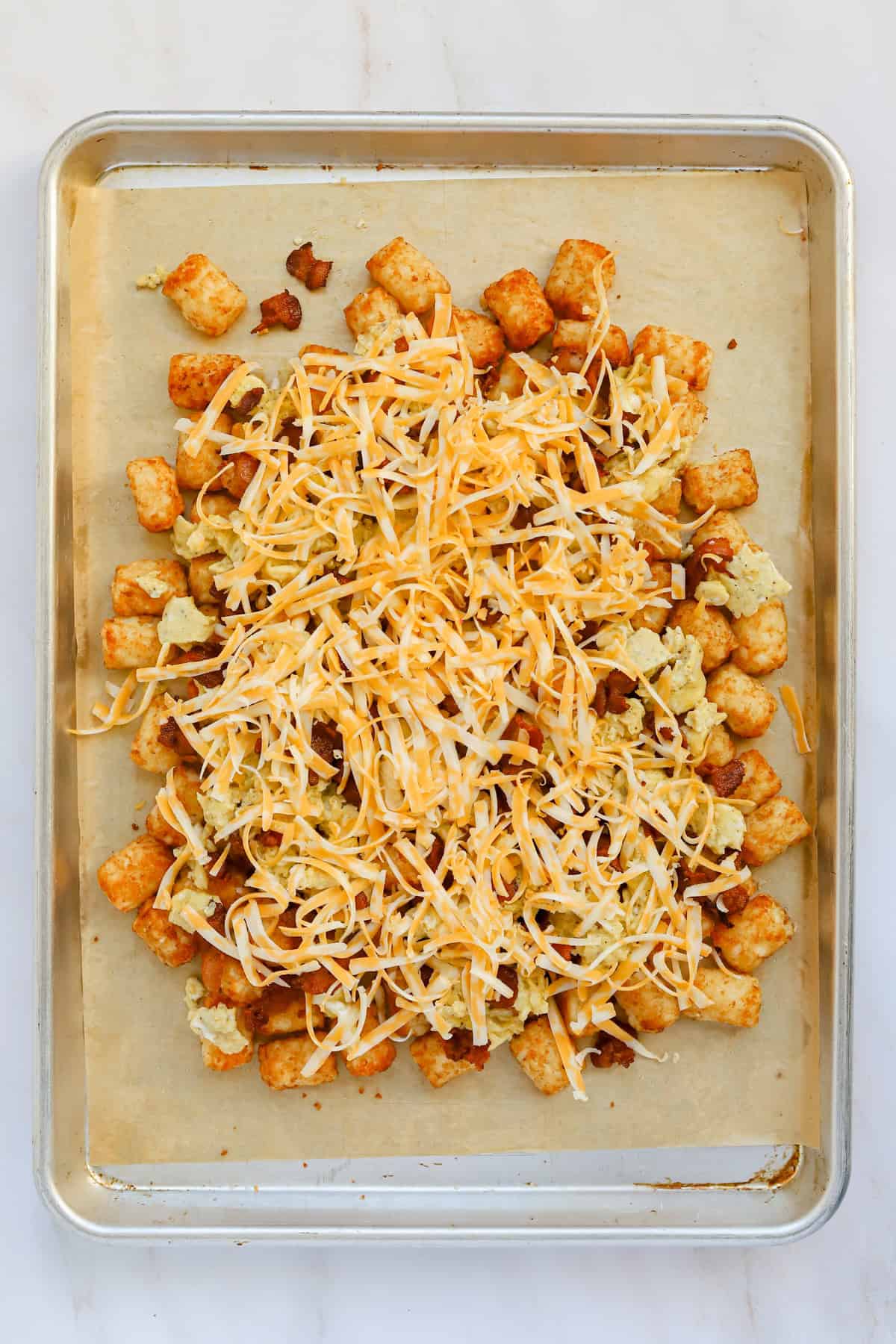Shredded Colby jack cheese on top of totchos