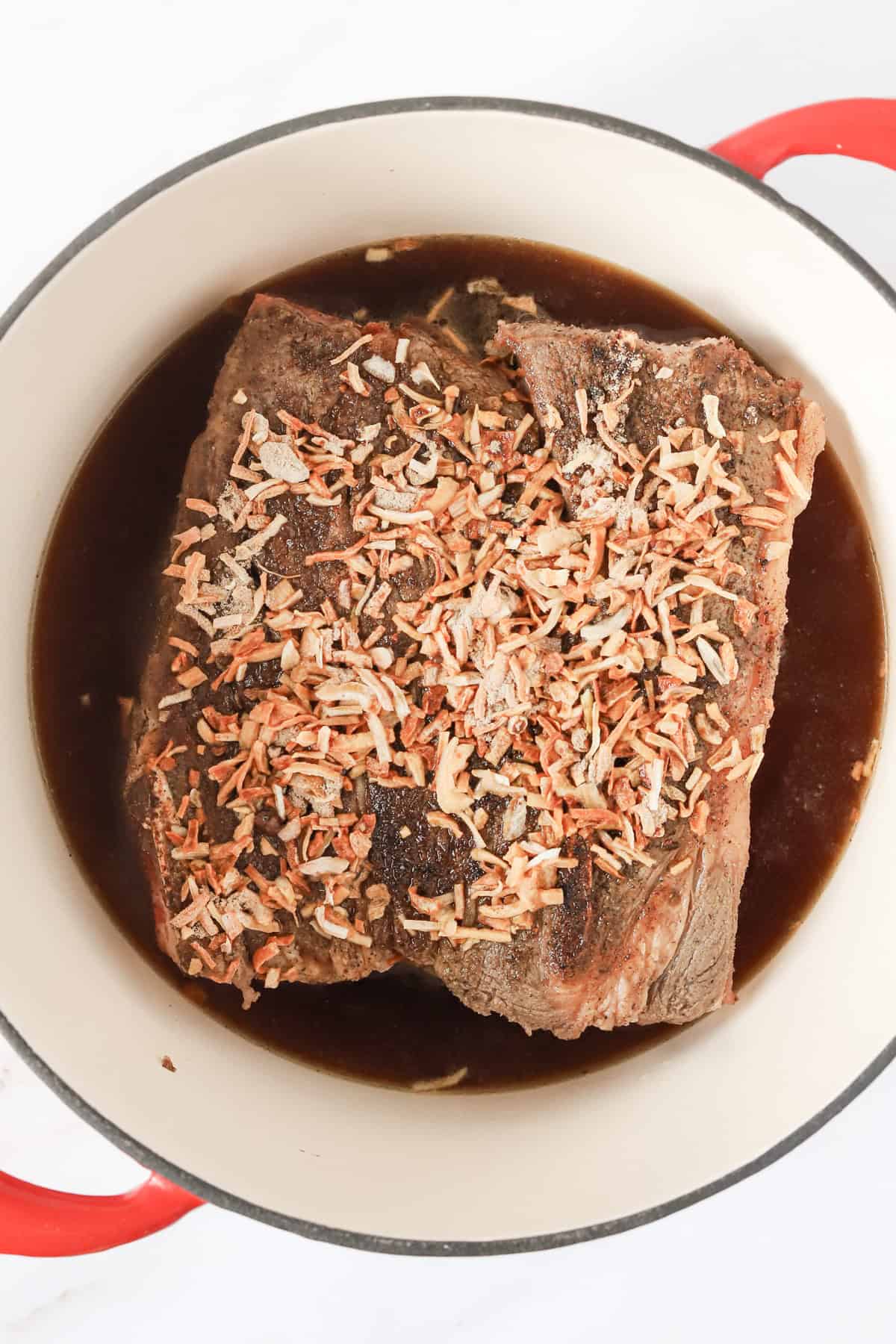 Dry Lipton onion soup mix sprinkled over the top of chuck roast in dutch oven.