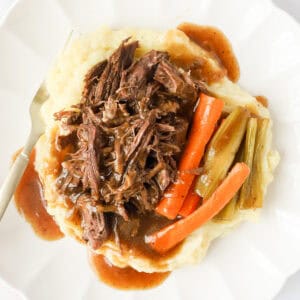 Featured image of plated pot roast, veggies, gravy and mashed potatoes.